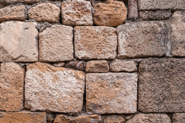 istock Texture of a stone wall. Old castle stone wall texture background. 1390494173