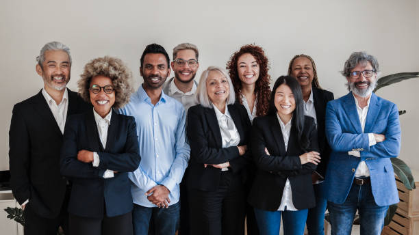 Multi-ethnic generational modern office: Successful business team smiling on camera - Focus on Asian girl face Multi-ethnic generational modern office: Successful business team smiling on camera - Focus on Asian girl face multi generation family stock pictures, royalty-free photos & images