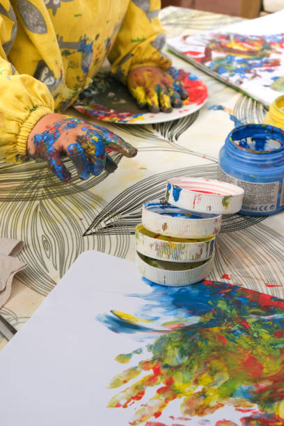 istock Early childhood development activity: finger painting outside on a sunny day 1390496682
