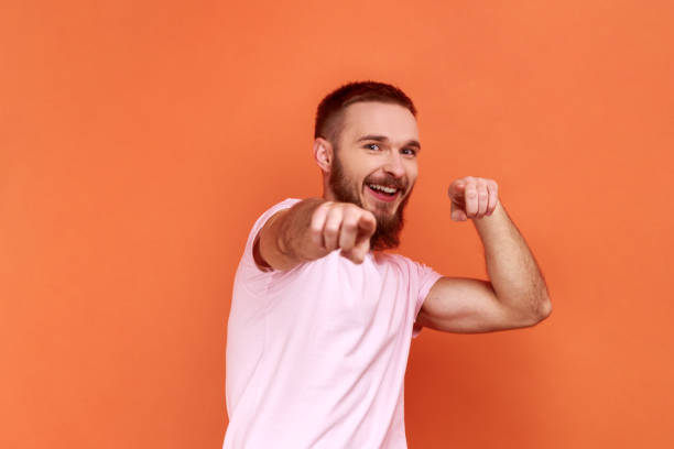istock Handsome man pointing to camera, smiling, making happy choice, we need you concept. 1390497833