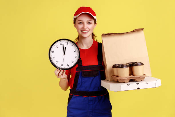 istock Courier woman holding wall clock and coffee with pizza box, express delivery in time. 1390497966