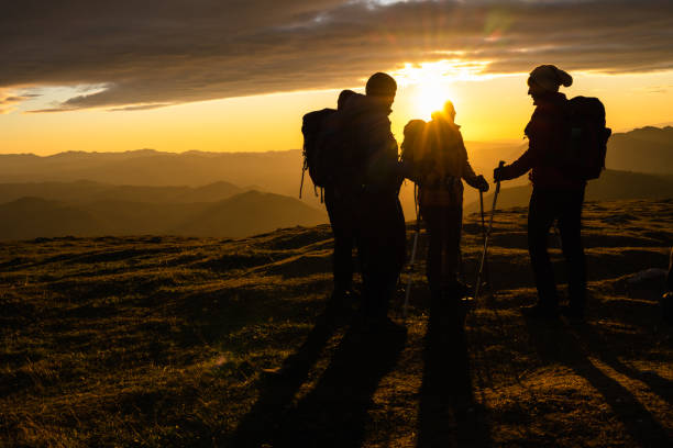 istock Silhouettes Of Hikers At Sunset 1390498056