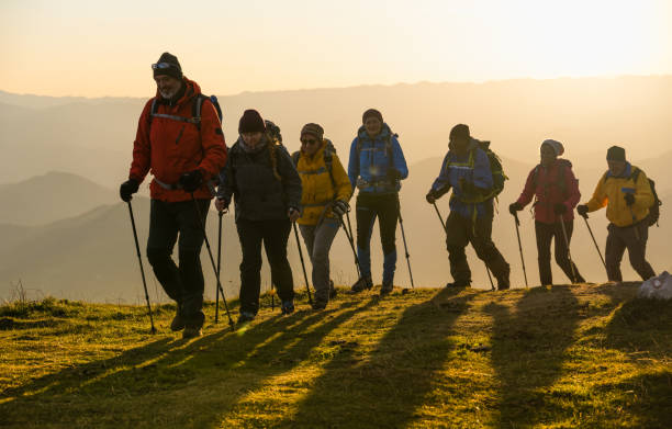 istock Silhouettes Of Hikers At Sunset 1390498057