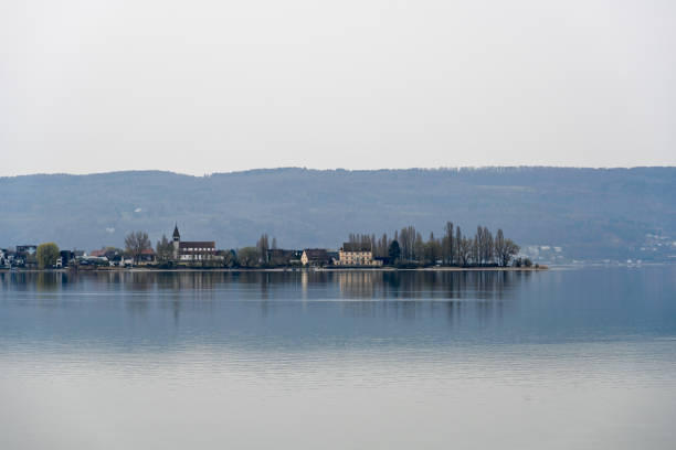 Wasserburg, Germany - June 30, 2013: Wasserburg on lake constance. In the background the church of St. George is seen. In the foreground the bridge to the ferry.