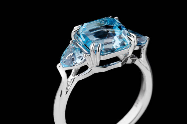 istock Beautiful gold ring with aquamarine and diamonds on a black background 1390501434