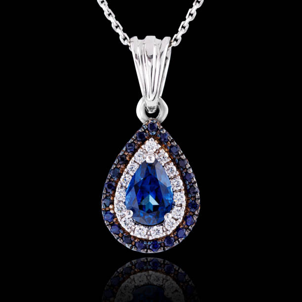 istock beautiful pendant with sapphire with a gold chain on a black background 1390501448