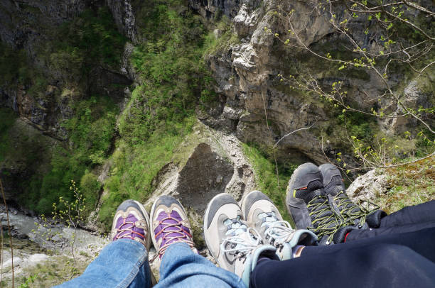 istock Legs in training shoes above canyon in mountains 1390501449