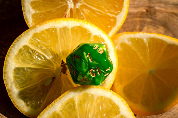 Green d20 on lemon slices stock photo