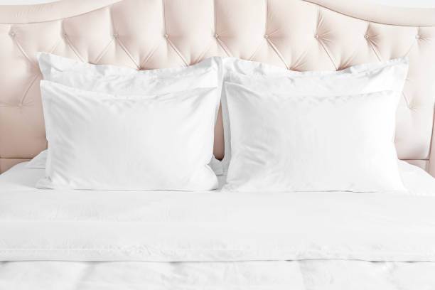 istock White pillows, duvet and duvet case on bed with beige headboard. 1390504437