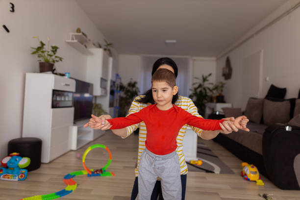 istock Little boy making first steps with help of his mother 1390505656
