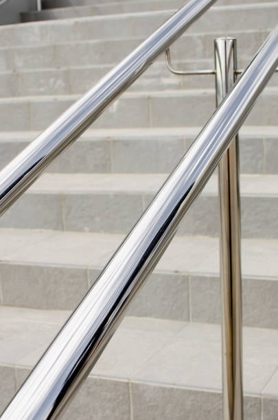 istock Round metal railing on a modern staircase, close-up. 1390507345
