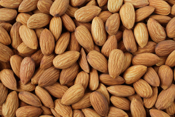 istock Background of big raw peeled almonds situated arbitrarily 1390509460