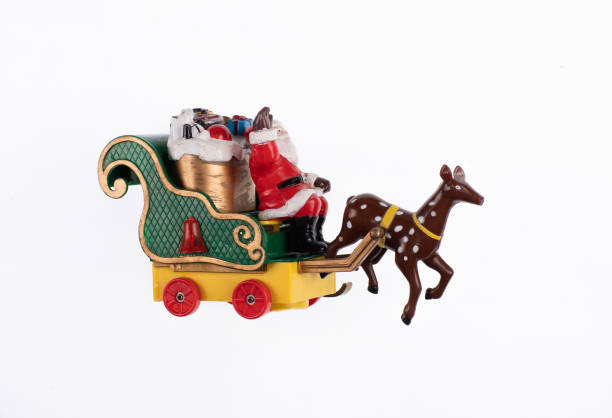 istock toy santa claus on carriage isolated on white background 1390512849