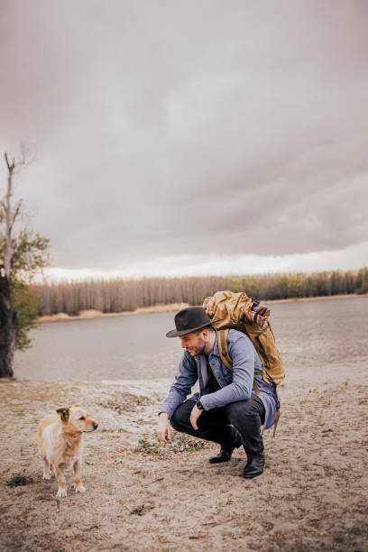 istock Young man playing with his dog outdoors 1390513017