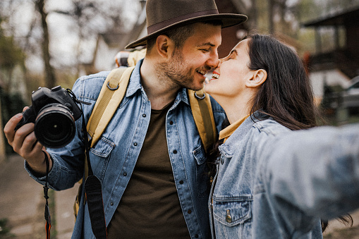 Self portrait of young happy couple kissing