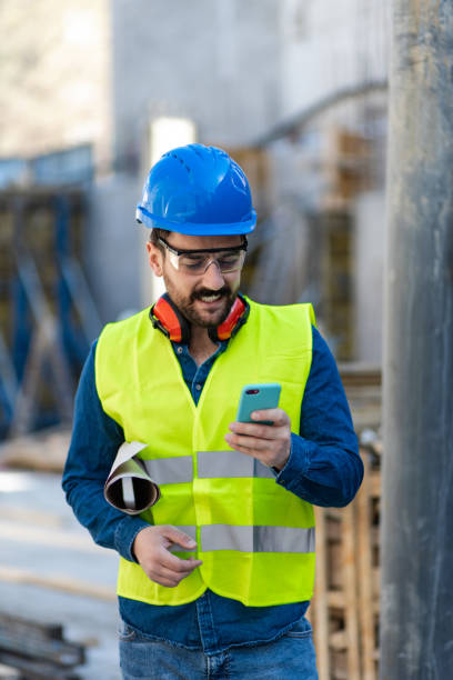 istock Construction site manager checks cell phone 1390515973