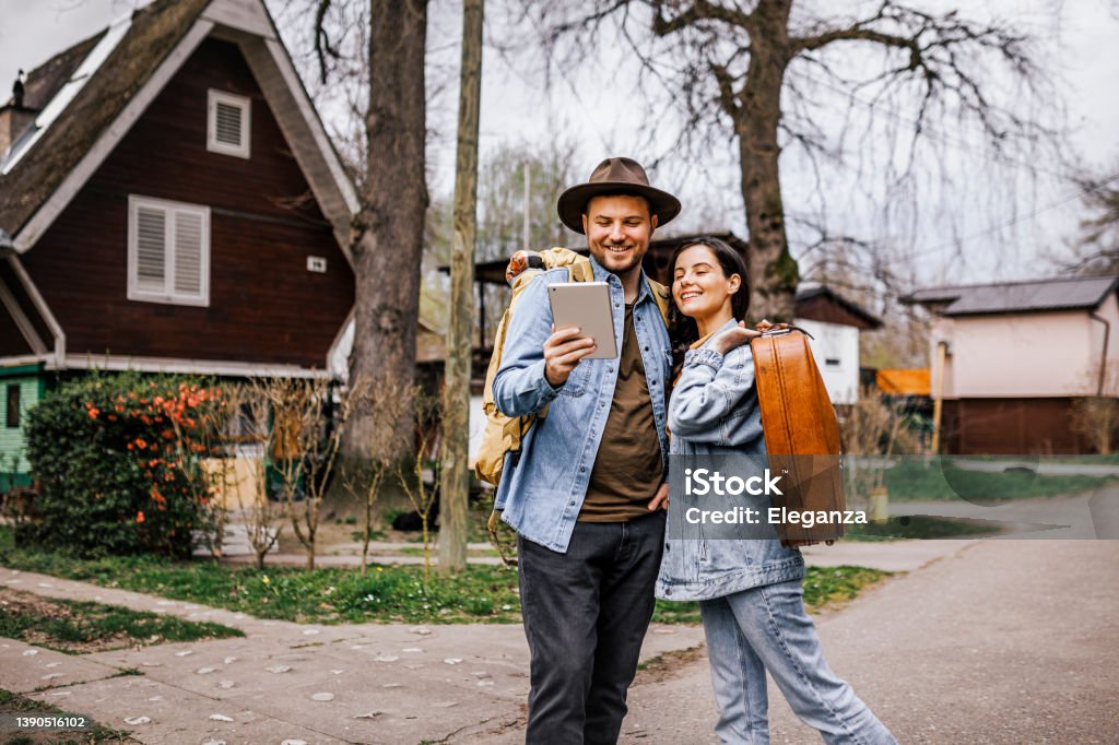 Portrait of young couple using digital tablet while exploring new travel destination Serbia Stock Photo