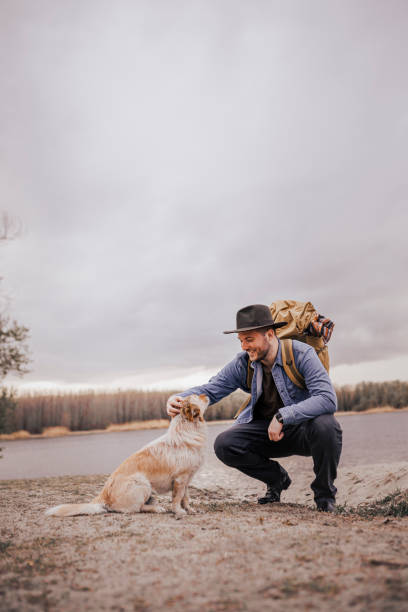 istock Young man playing with his dog outdoors 1390516656