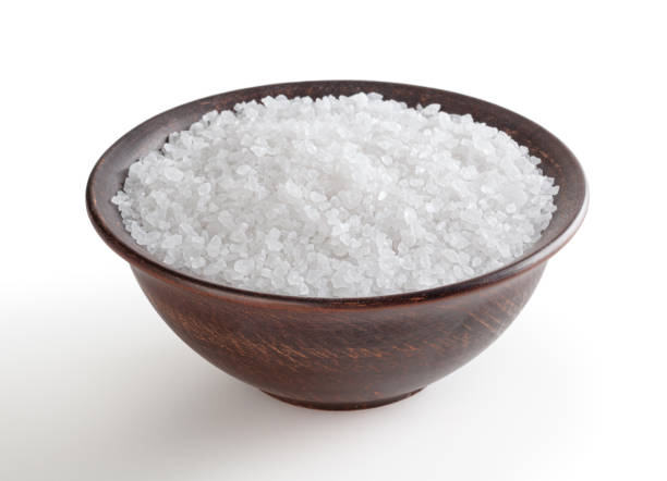 istock Sea salt in ceramic bowl isolated on white background with clipping path 1390517110