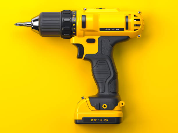 istock Yellow electric screwdriver drill on yellow background. 1390517145