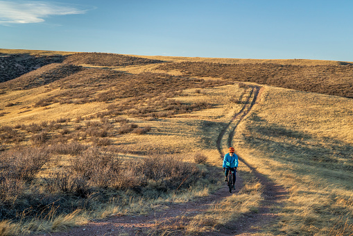 senior male cyclist is riding a gravel bike on a trail in Colorado foothills in early spring scenery, Soapstone Prairie Natural Area