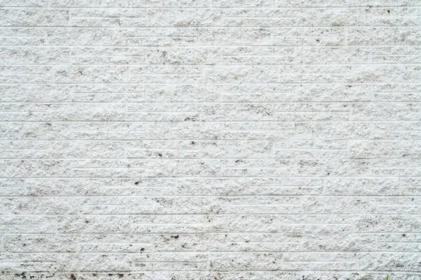 old brick or stone wall background texture painted white