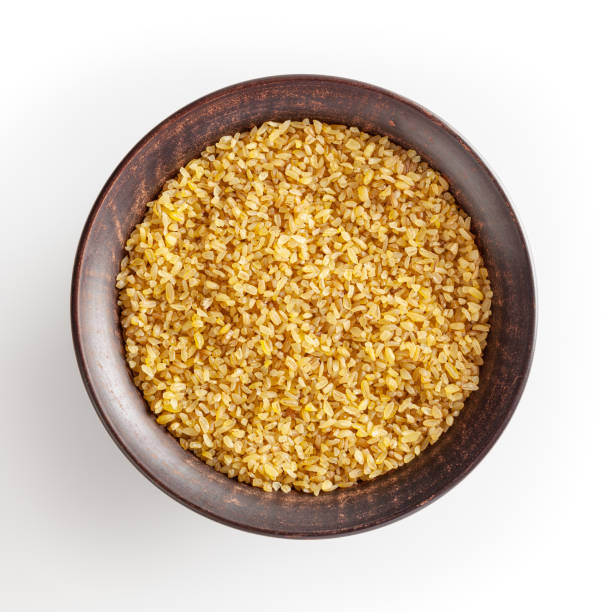 istock Dried bulgur in ceramic bowl isolated on white background with clipping path 1390518456