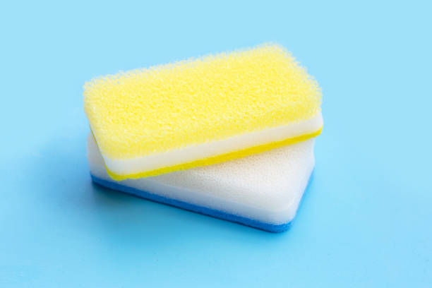 istock Cleaning kitchen dishwashing sponge. Blue background. 1390521832