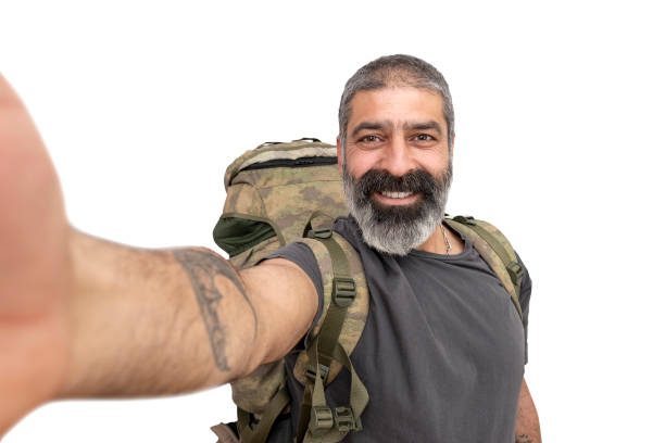 middle aged bearded man wearing camping bag taking selfie smiling. - tourist photographing armed forces military imagens e fotografias de stock