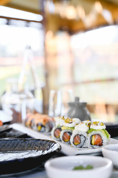 istock japanese dinner in a restaurant with serving sushi rolls in a plate. close up with selective focus 1390524779