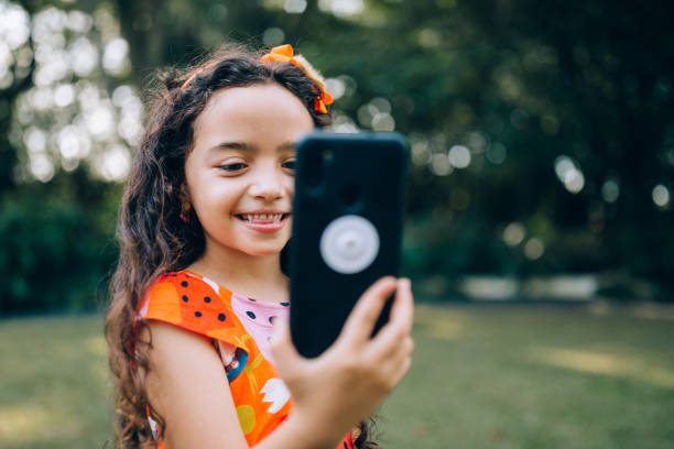 istock Young girl using cell phone 1390527046
