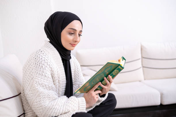 istock Muslim young woman reading Koran 1390528207