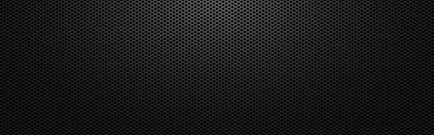 Vector illustration of Black metal background. Perforated dark texture with light. Carbon sheet with holes. Abstract steel wallpaper wide. Modern composite material. Vector illustration