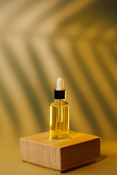 istock Front view of amber colored essential oil bottle with pipette 1390531971