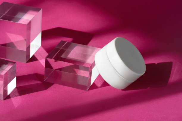 istock Body cream blank cosmetic mock up on transparent solid blocks with shadows and reflection. Jar of organic lotion standing on glass cube podium pedestal showcase. 1390533636