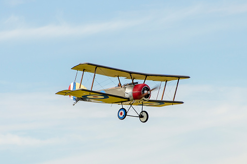 Old retro plane flies in the sky.