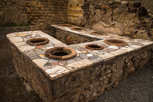 These large vats held food that was sold to people in the street.  This vending area is located in the town of Herculaneum which was buried in lava during the eruption of Mount Vesuvius in 79AD.