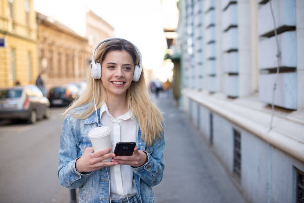 istock Happy young woman using phone 1390537691