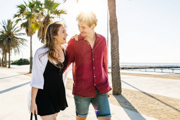 Happy couple in love walking together while enjoying their summer vacation Happy couple in love walking together while enjoying their summer vacation. Summer, beach and relationship concept. barcelona province stock pictures, royalty-free photos & images