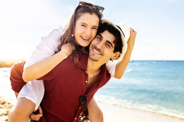 istock Hipster man piggybacking his trendy girlfriend 1390537861