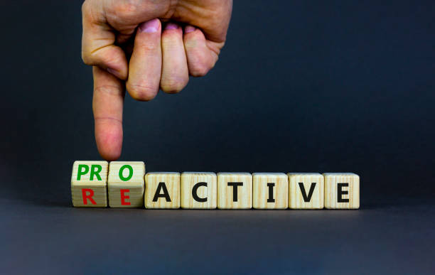 Reactive or proactive symbol. Businessman turns wooden cubes and changes the word reactive to proactive. Business and reactive or proactive concept. Beautiful grey background, copy space. stock photo