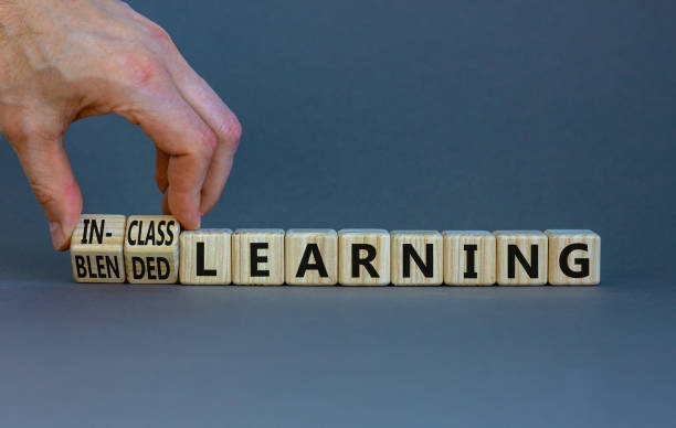 istock Blended or in-class learning symbol. Businessman turns cubes, changes words blended learning to in-class learning. Grey background. Education and blended or in-class learning concept. Copy space. 1390539546