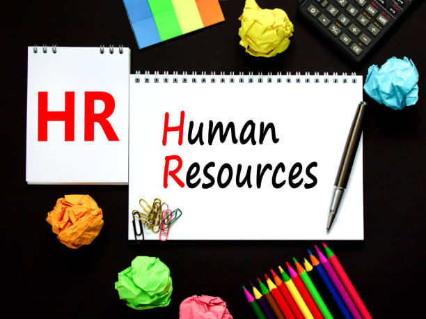 istock HR Human resources symbol. Concept words HR Human resources on white note. Metallic pen, calculator, pencil. Beautiful black background. Business and HR human resources concept. 1390539551
