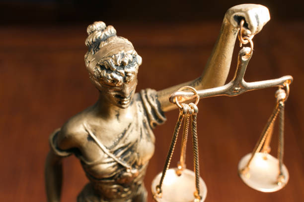 lady justice on wooden background golden lady justice on wooden background courtroom stock pictures, royalty-free photos & images