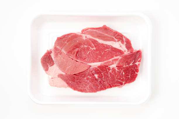 istock Fresh raw beef steak on foam tray on white background 1390542549