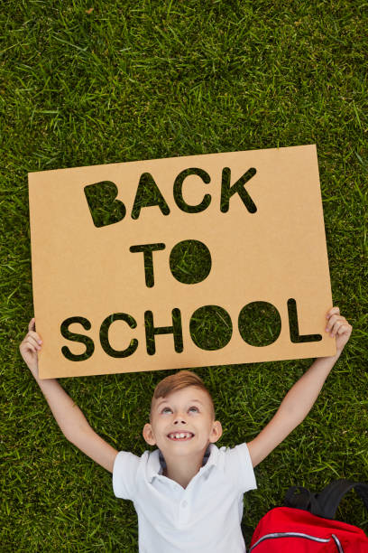 istock Delighted boy with Back To School poster 1390551557