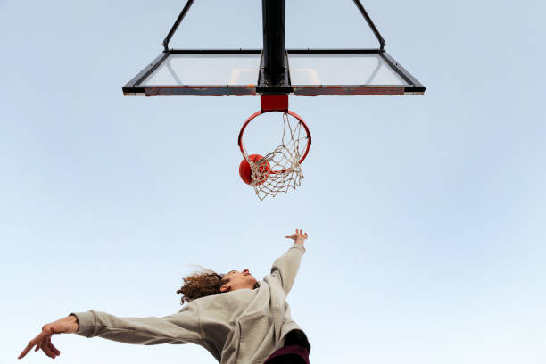 istock man shooting in a basketball hoop seen from below 1390551785