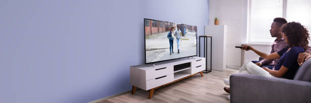 Affectionate Young Family Watching TV At Home