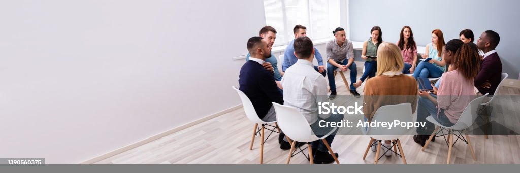 Multi-ethnic People Sitting In Circle Counseling Young Multiracial Millennial Friends Sitting In Circle Having Group Discussion Psychotherapy Stock Photo