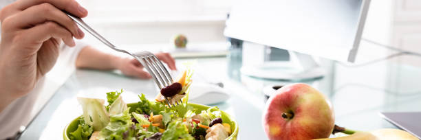 istock Healthy Salad On Office Desk 1390560380